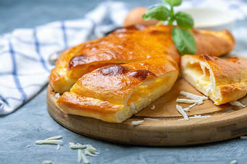 Image showing Cut closed pie with cheese and egg (khachapuri).