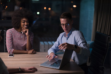 Image showing Multiethnic startup business team in night office