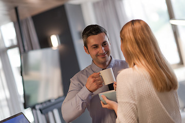 Image showing A young couple is preparing for a job and using a laptop