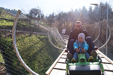 Image showing father and son enjoys driving on alpine coaster