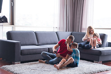 Image showing Happy family playing a video game