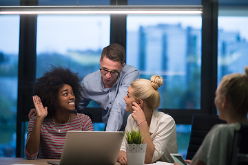 Image showing Multiethnic startup business team in night office