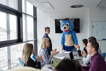 Image showing boss dresed as bear having fun with business people in trendy of