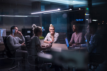 Image showing Multiethnic startup business team in night office