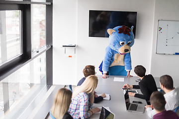 Image showing boss dresed as bear having fun with business people in trendy of