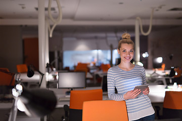 Image showing woman working on digital tablet in night office