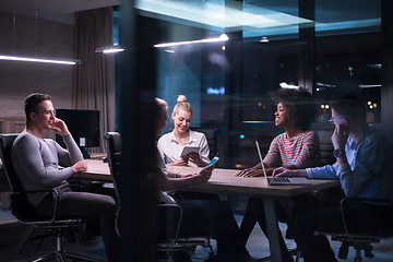 Image showing Multiethnic startup business team in night office