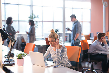 Image showing businesswoman using a laptop in startup office