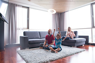 Image showing Happy family playing a video game