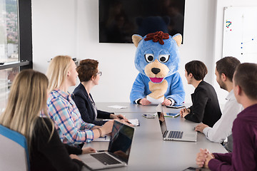 Image showing boss dresed as bear having fun with business people in trendy of