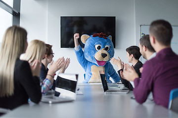 Image showing boss dresed as bear having fun with business people in trendy of