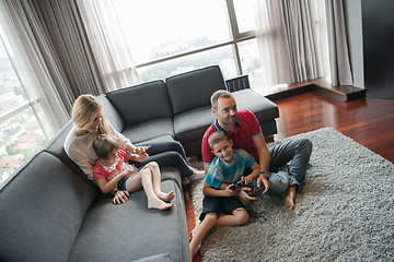 Image showing Happy family playing a video game