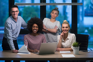 Image showing Multiethnic startup business team in night office