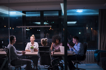 Image showing Multiethnic startup business team in night office