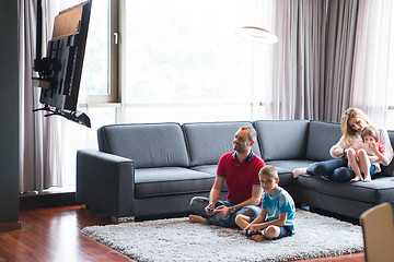 Image showing Happy family playing a video game