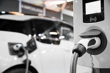 Image showing Electric car getting recharged at station