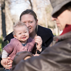 Image showing Young family with cheerful child in the park.