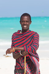 Image showing Traditonaly dressed maasai black man on picture perfect tropical Paje beach, Zanzibar, Tanzania, East Africa.