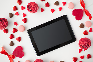 Image showing close up of tablet pc and sweets on valentines day