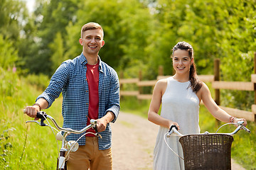 Image showing happy couple with bicycles at summer park