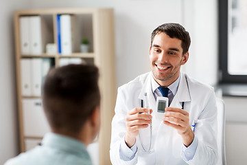 Image showing doctor with glucometer and patient at hospital