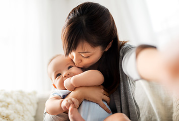 Image showing happy mother with little baby son taking selfie