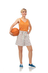 Image showing smiling teenage girl in headphones with basketball