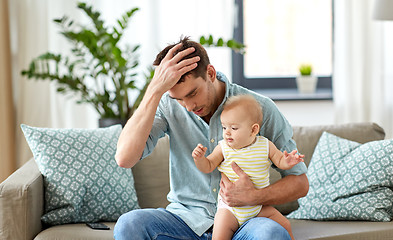 Image showing despaired father with little baby daughter at home