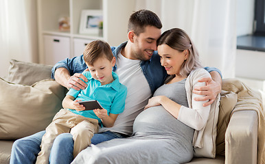 Image showing happy family with smartphone at home