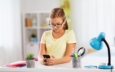 Image showing student girl with smartphone doing homework