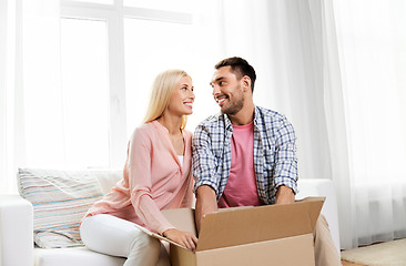 Image showing happy couple with open parcel box at home