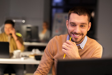 Image showing man with computer working late at night office