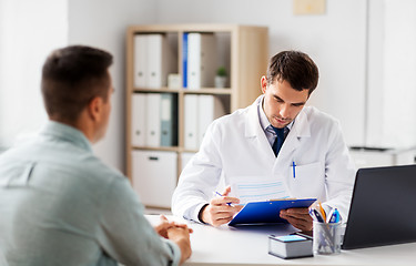 Image showing doctor with clipboard and male patient at hospital