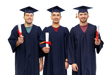 Image showing male graduates in mortar boards with diplomas