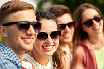 Image showing happy teenage friends in sunglasses outdoors