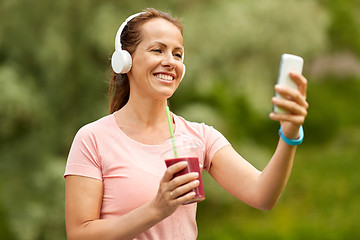 Image showing woman with smartphone and shake listening to music