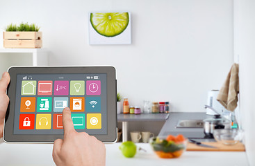 Image showing hands with smart home icons on tablet computer