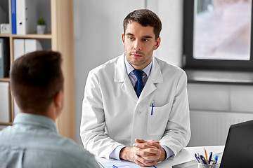 Image showing doctor listening to male patient at hospital