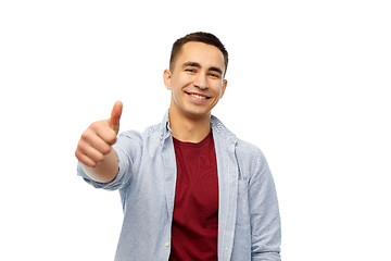 Image showing happy young man showing thumbs up