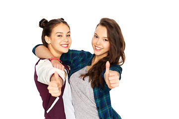 Image showing happy teenage girls hugging and showing thumbs up