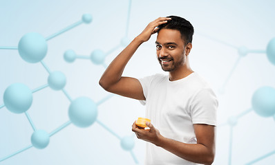 Image showing indian man applying hair wax or styling gel