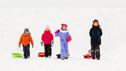 Image showing happy little kids with sleds in winter