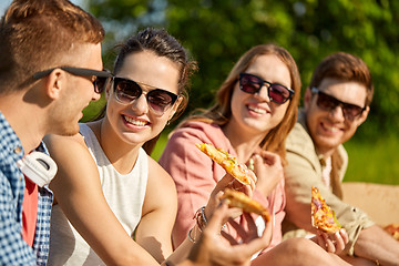 Image showing friends eating pizza at picnic in summer park