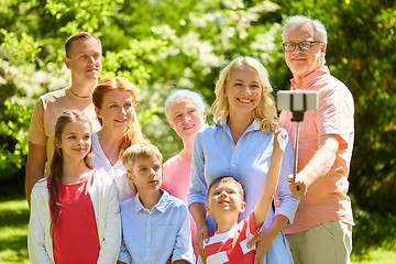 Image showing happy family taking selfie in summer garden