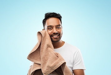 Image showing smiling indian man with towel over blue background