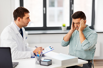 Image showing doctor and male patient having headache at clinic