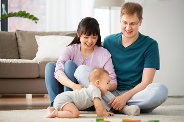 Image showing happy mixed race family with baby son at home