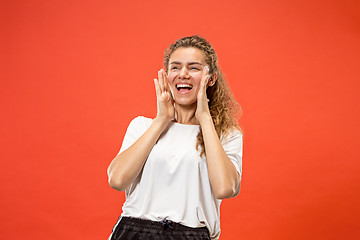 Image showing Isolated on pink young casual woman shouting at studio