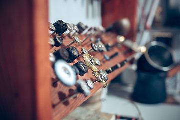 Image showing Different goldsmiths tools on the jewelry workplace. work in jewelry.