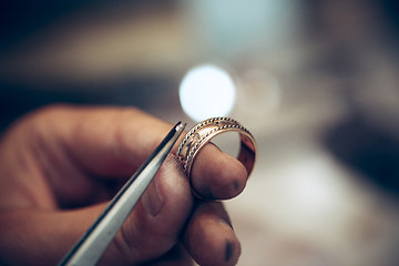 Image showing Different goldsmiths tools on the jewelry workplace. Jeweler at work in jewelry.